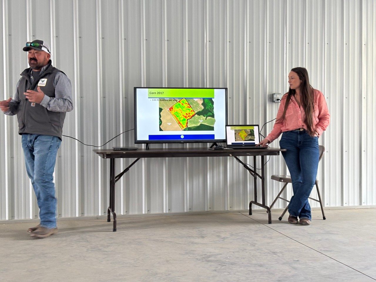 industry speakers showing students field data on a large screen